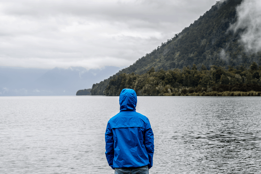 person wearing blue hoodie near river; Photo by Gabriela Palai from Pexels